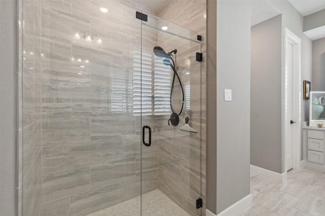 full bathroom featuring a shower stall and baseboards