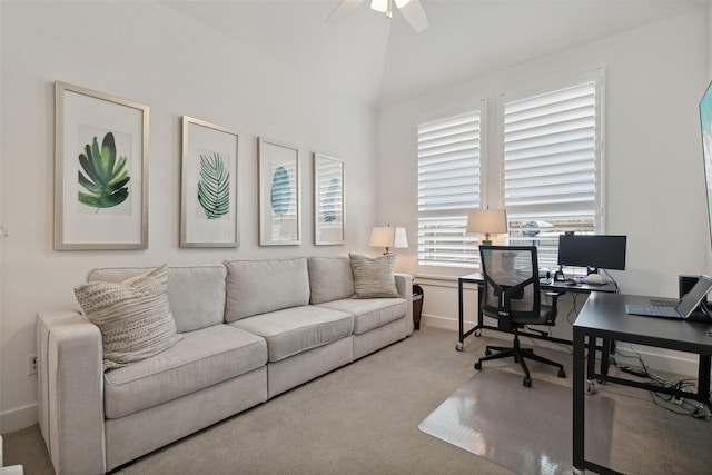 carpeted office featuring a ceiling fan, vaulted ceiling, and baseboards