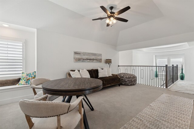carpeted living room with a ceiling fan and lofted ceiling