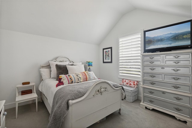 bedroom with light carpet, multiple windows, and vaulted ceiling