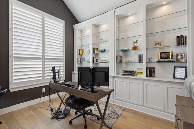 office space featuring vaulted ceiling and light hardwood / wood-style floors