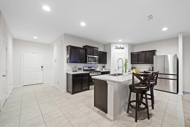 16501 Portage St, Justin, TX 76247 - kitchen with appliances with stainless steel finishes, a sink, light tile patterned floors, light countertops, and recessed lighting
