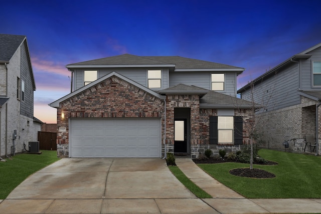 front of property with central AC, a yard, and a garage