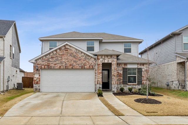 view of front property with a garage and central AC