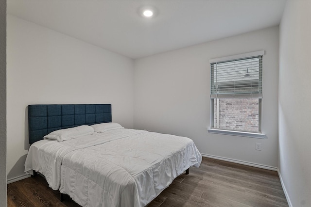 bedroom with dark wood-type flooring