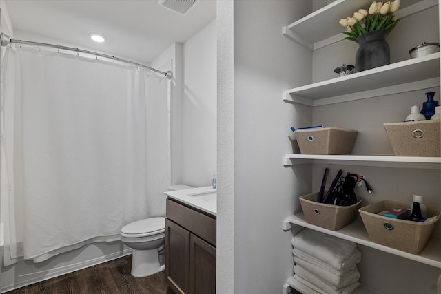 bathroom featuring vanity, hardwood / wood-style flooring, and toilet