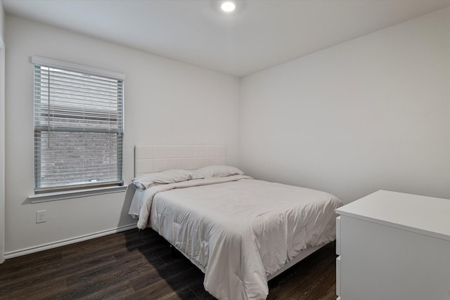 bedroom with dark hardwood / wood-style flooring