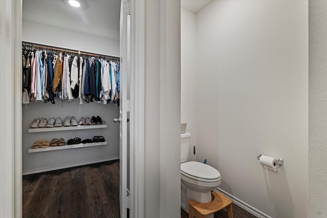 bathroom with hardwood / wood-style flooring and toilet