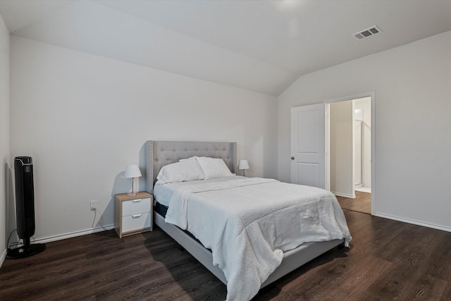 bedroom featuring lofted ceiling and dark hardwood / wood-style floors