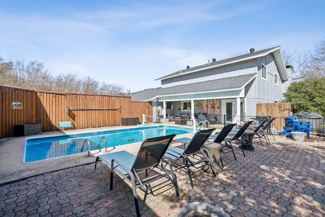 view of swimming pool with a fenced in pool, a fenced backyard, and a patio