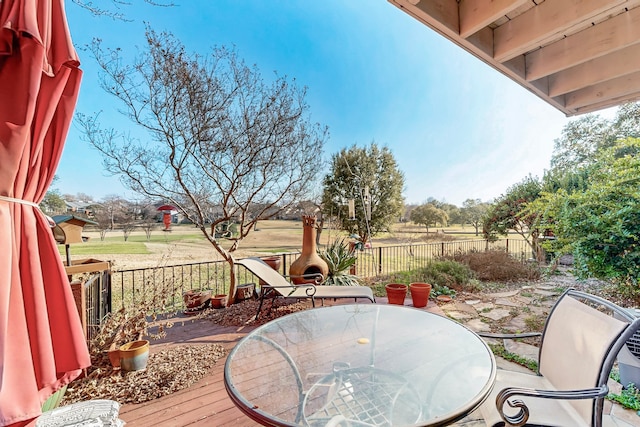 deck with outdoor dining space and fence