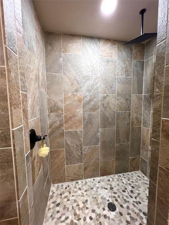 bathroom with a tile shower