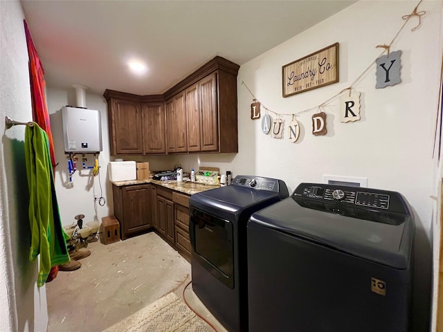 washroom featuring independent washer and dryer, cabinets, and water heater