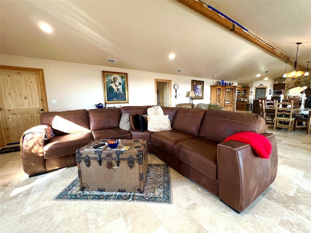 living room with lofted ceiling with beams