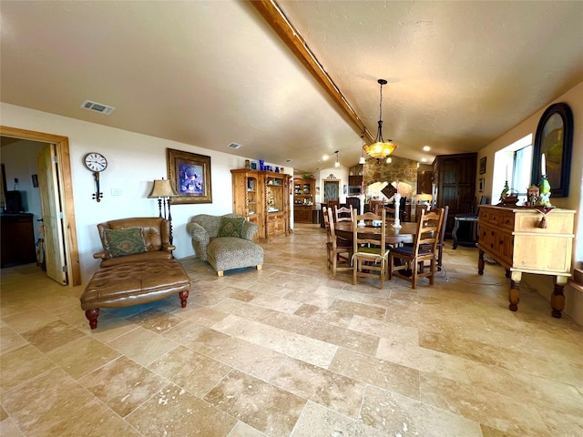 dining area with lofted ceiling with beams