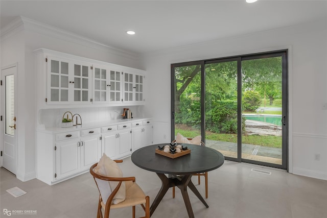 dining room with ornamental molding and plenty of natural light