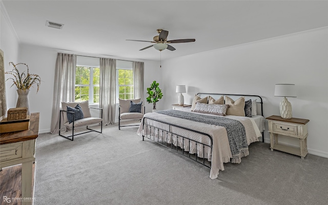 bedroom with crown molding, light colored carpet, and ceiling fan