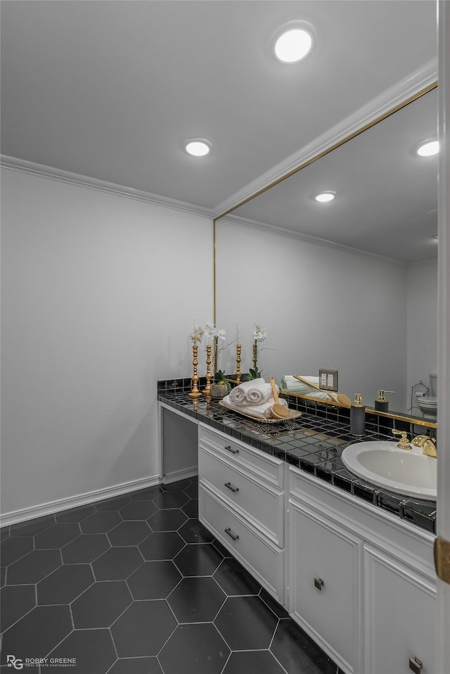 bathroom featuring tile patterned flooring, ornamental molding, and vanity