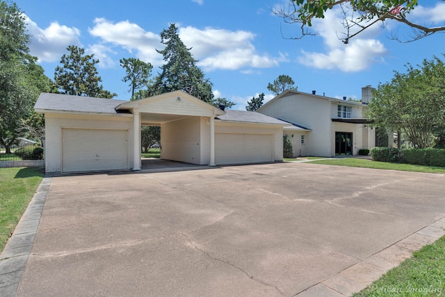 view of front of house with a carport and a garage