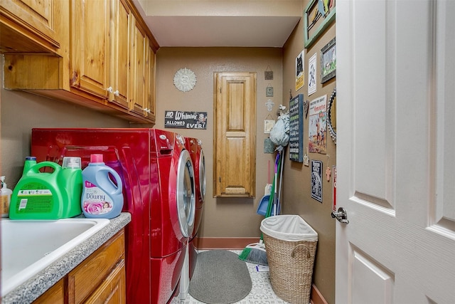 washroom featuring cabinets, independent washer and dryer, and sink