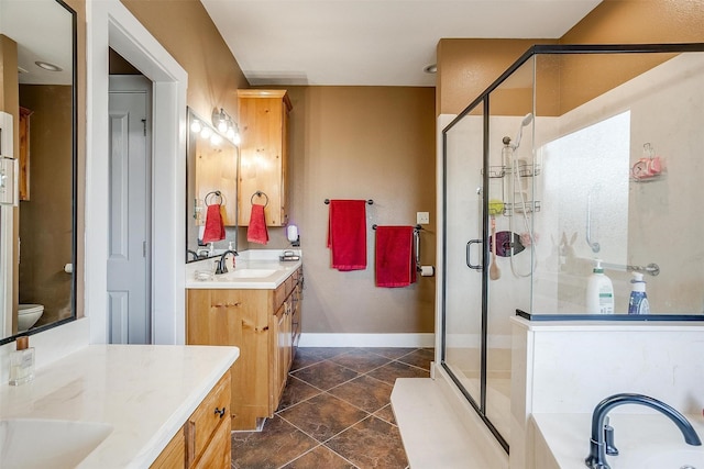 bathroom featuring vanity, toilet, and walk in shower