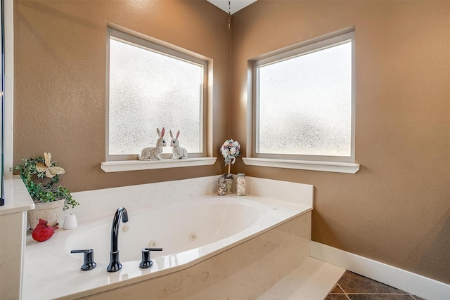 bathroom featuring tile patterned flooring and a bath