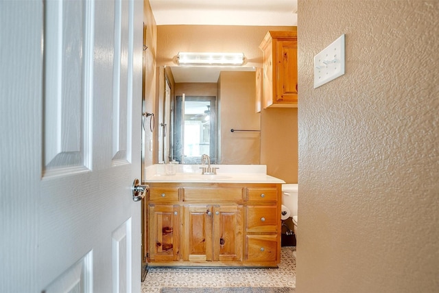 bathroom featuring vanity and toilet