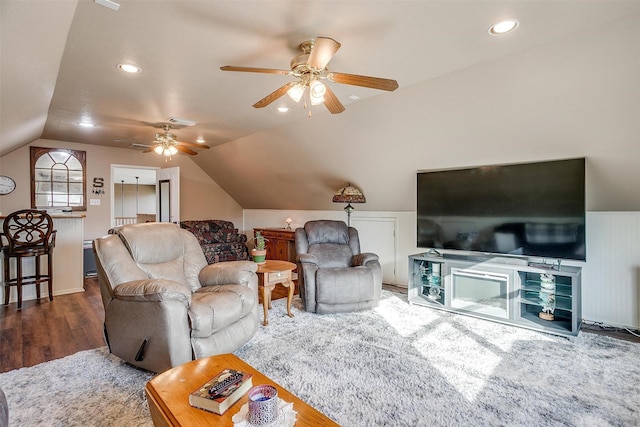 living room with ceiling fan, lofted ceiling, and dark hardwood / wood-style flooring