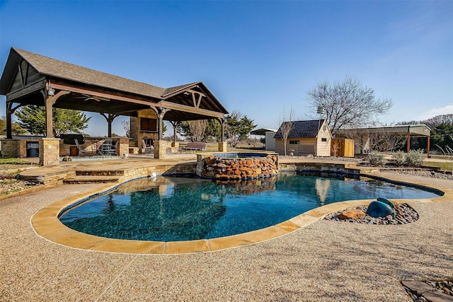 view of swimming pool with an outdoor stone fireplace, a gazebo, an in ground hot tub, a patio area, and exterior bar