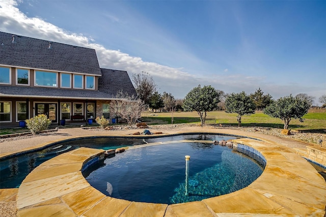 view of swimming pool with an in ground hot tub