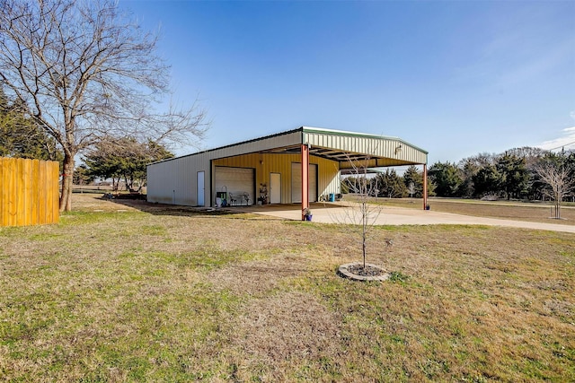 view of outdoor structure with a garage and a yard