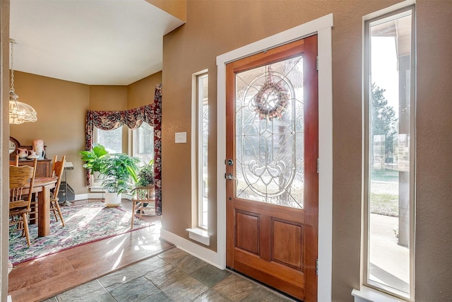 foyer entrance featuring an inviting chandelier