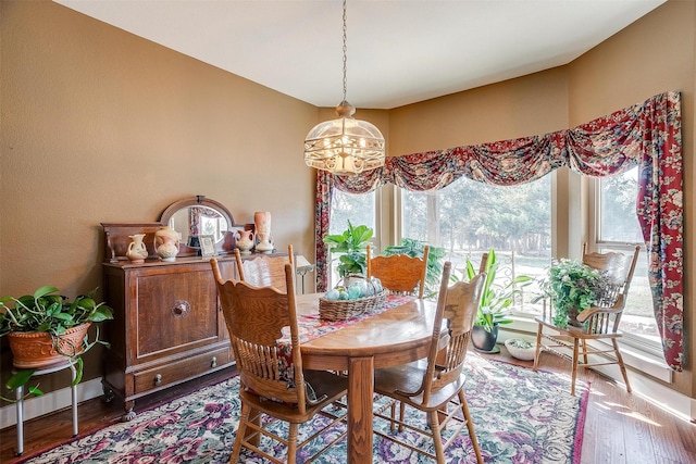 dining area featuring a notable chandelier and hardwood / wood-style flooring