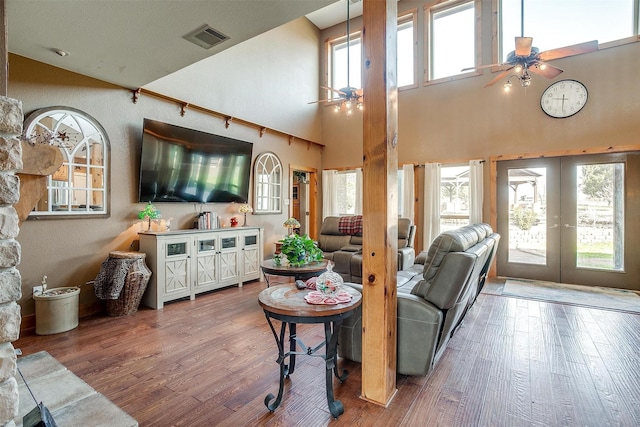 living room with hardwood / wood-style floors, french doors, and ceiling fan