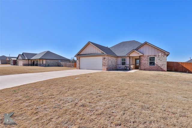 view of front of house with a garage and a front lawn