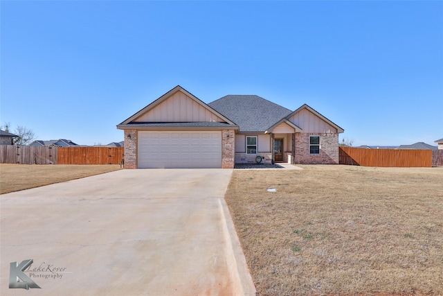 view of front of home featuring a garage and a front lawn