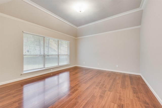 unfurnished room with crown molding and hardwood / wood-style flooring