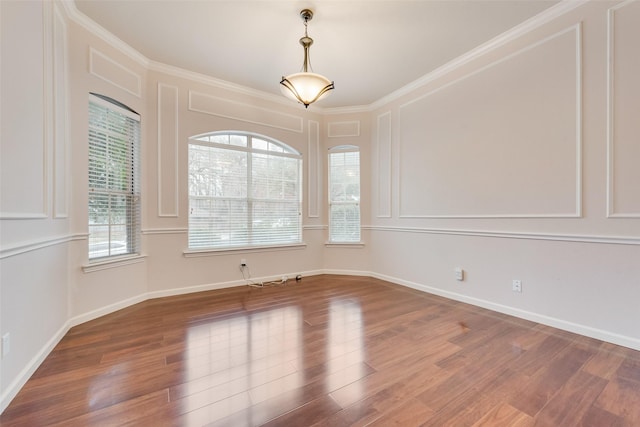 unfurnished room featuring wood-type flooring and ornamental molding