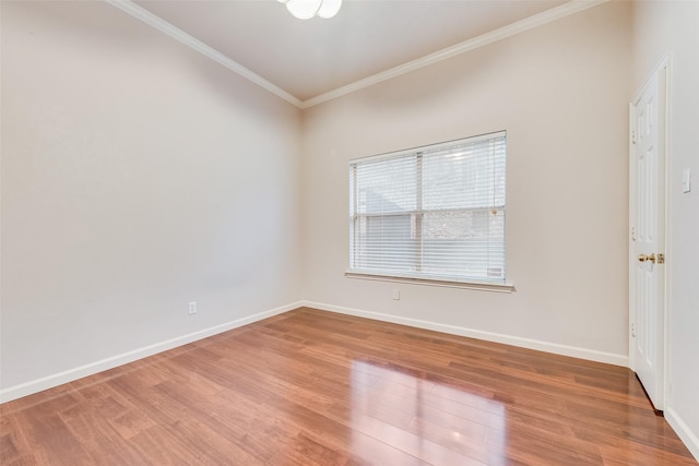 empty room featuring ornamental molding and wood-type flooring