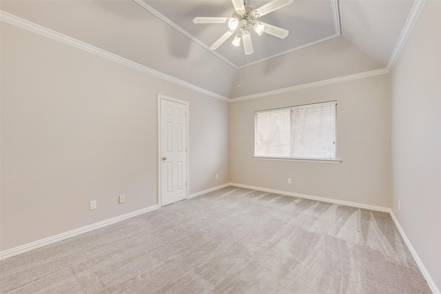 carpeted spare room with vaulted ceiling, ornamental molding, and ceiling fan