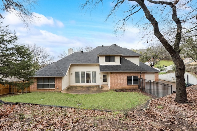 rear view of house featuring a patio and a yard