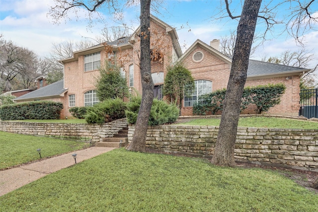 view of property featuring a front lawn