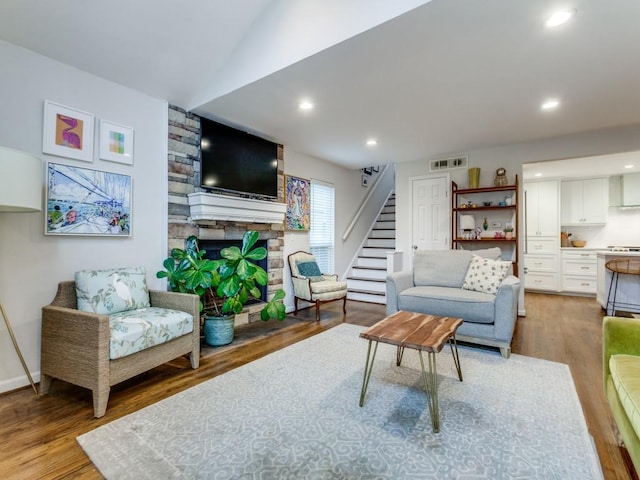 7010 San Mateo Blvd, Dallas, TX 75223 - living area with stairway, wood finished floors, a fireplace, recessed lighting, and lofted ceiling