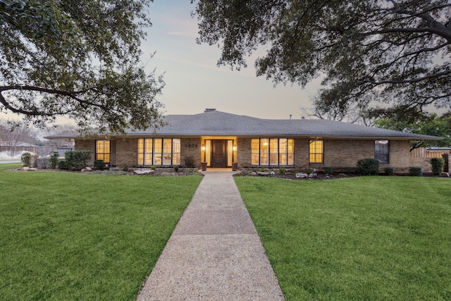 ranch-style home featuring a yard