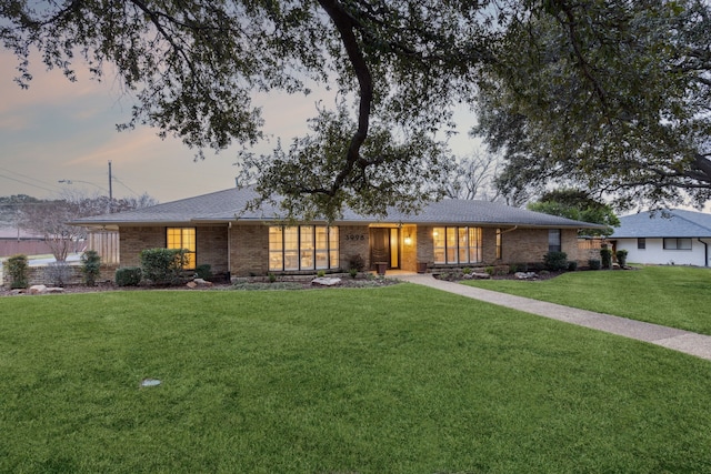 ranch-style house featuring a yard