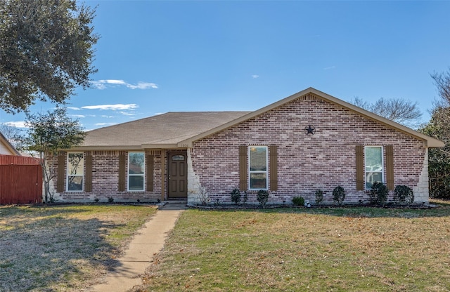 ranch-style house with brick siding, a front lawn, and fence