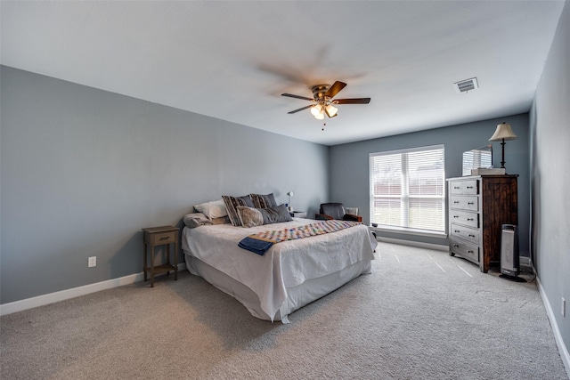 bedroom featuring light carpet, ceiling fan, visible vents, and baseboards