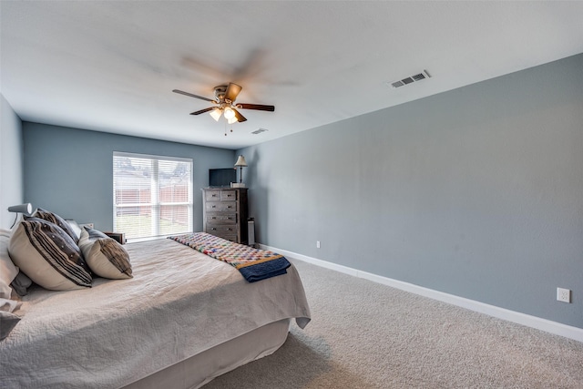 carpeted bedroom with ceiling fan, visible vents, and baseboards