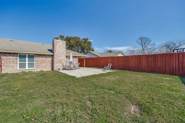 view of yard featuring a patio area and a fenced backyard