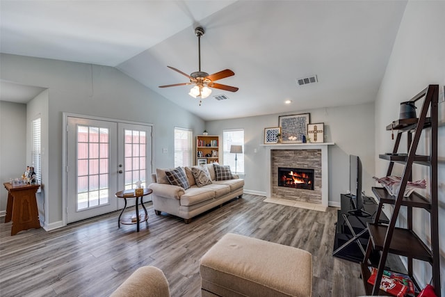 living room with lofted ceiling, french doors, wood finished floors, and visible vents